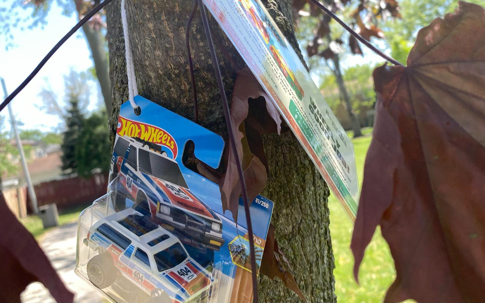 an image of a hot wheels truck hanging in a tree for the touch-a-truck scavenger hunt