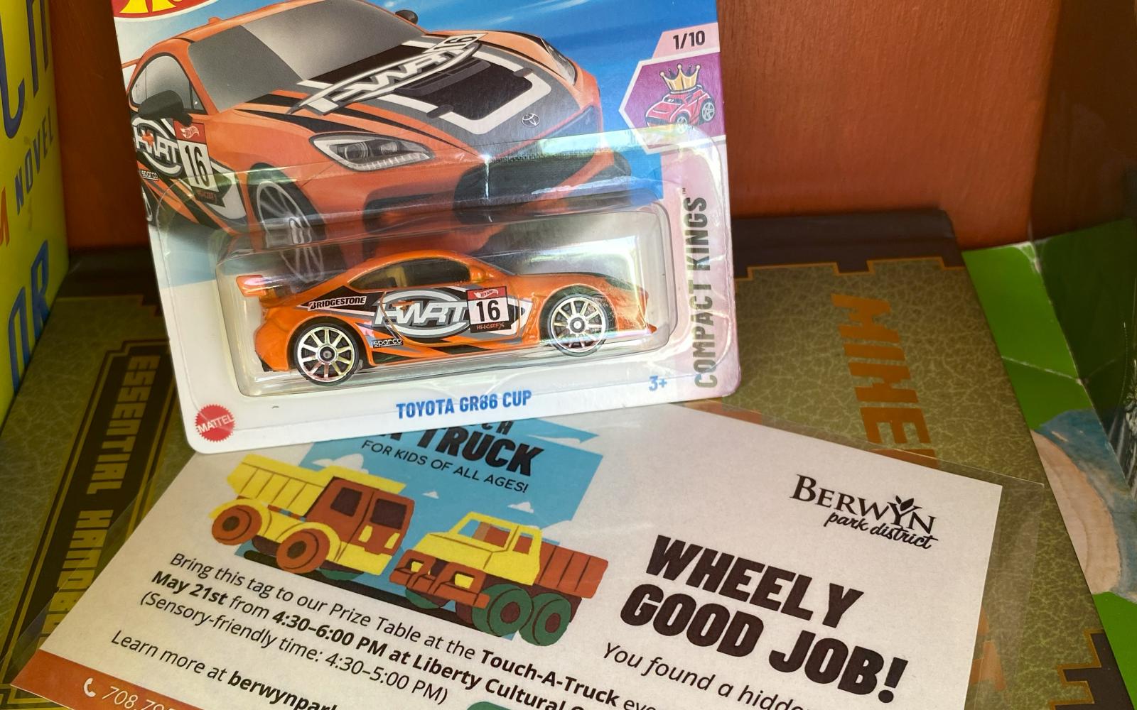 an image of a hot wheels truck hanging in a cupboard for the touch-a-truck scavenger hunt