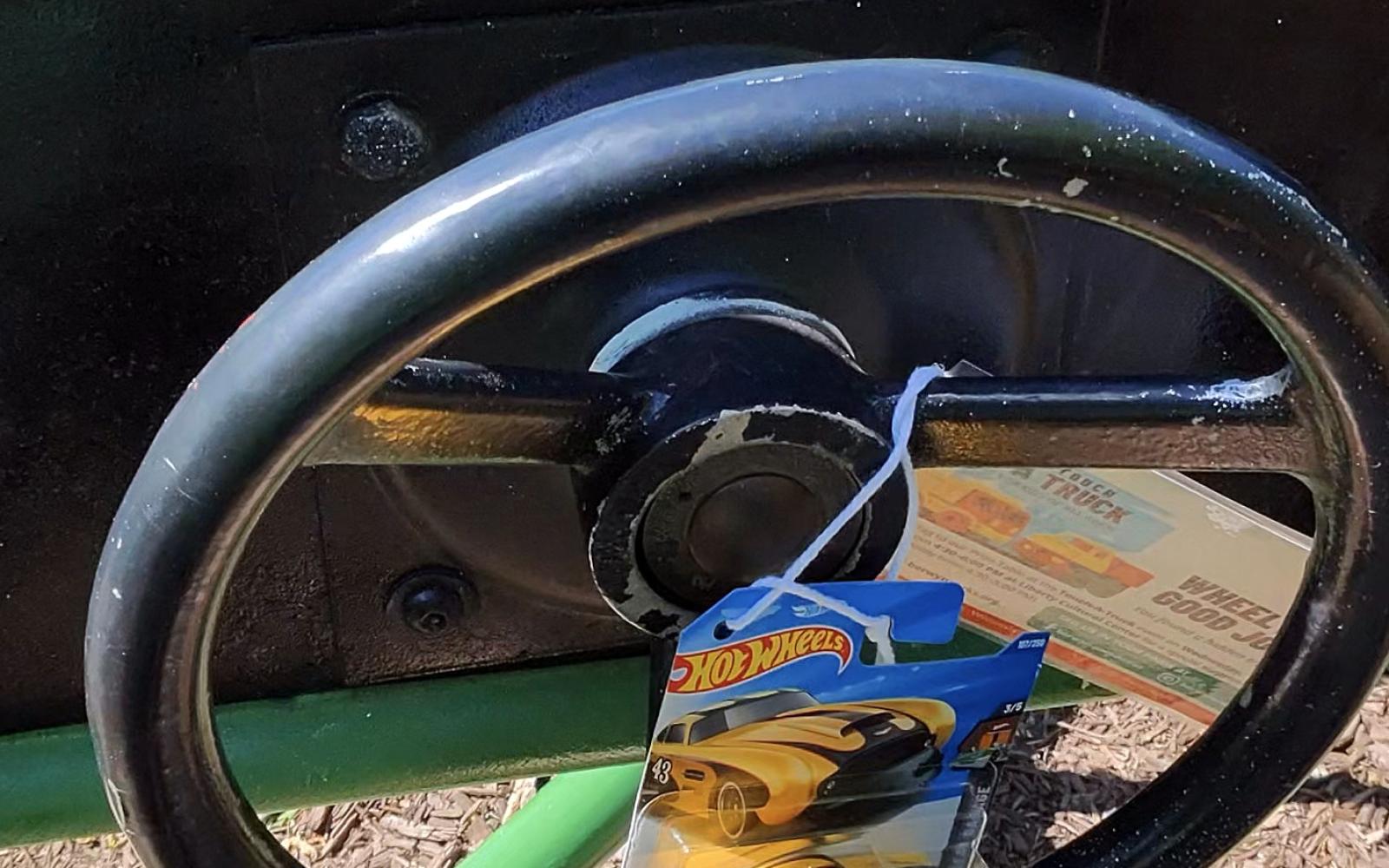 an image of a hot wheels truck hanging on a wheel for the touch-a-truck scavenger hunt