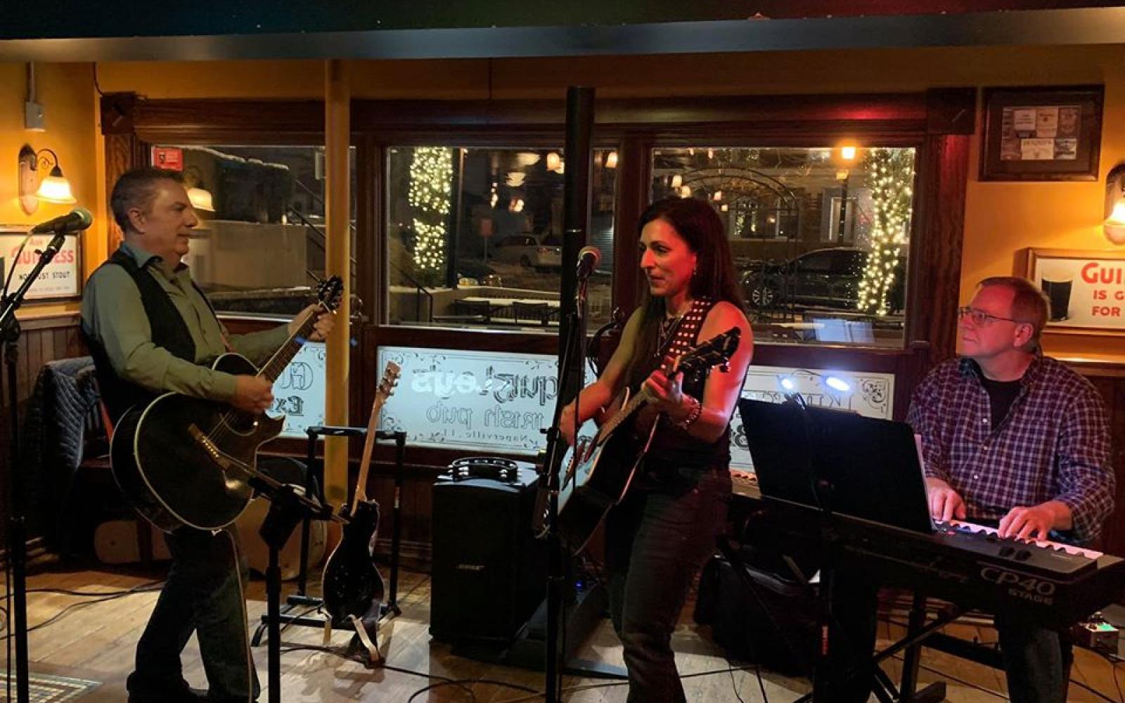 an image of Call Me Jo Band playing instruments and singing in a local establishment