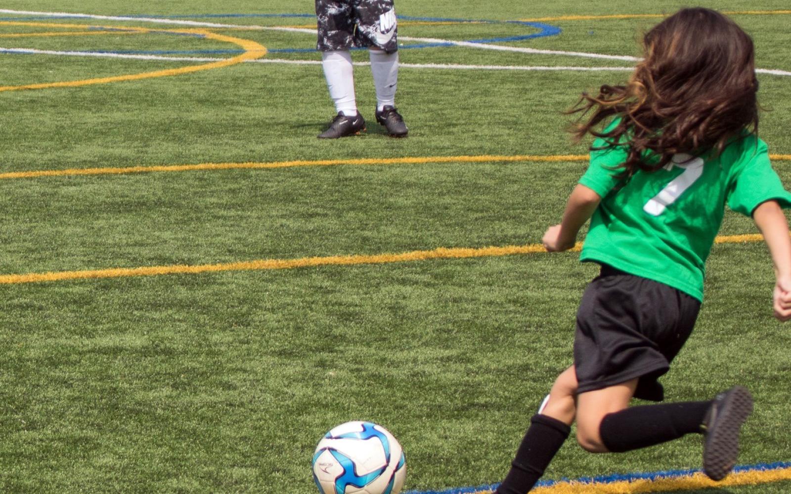 Photo of a child kicking a soccer ball at the Berwyn Park District's youth soccer league for youth athletics programs