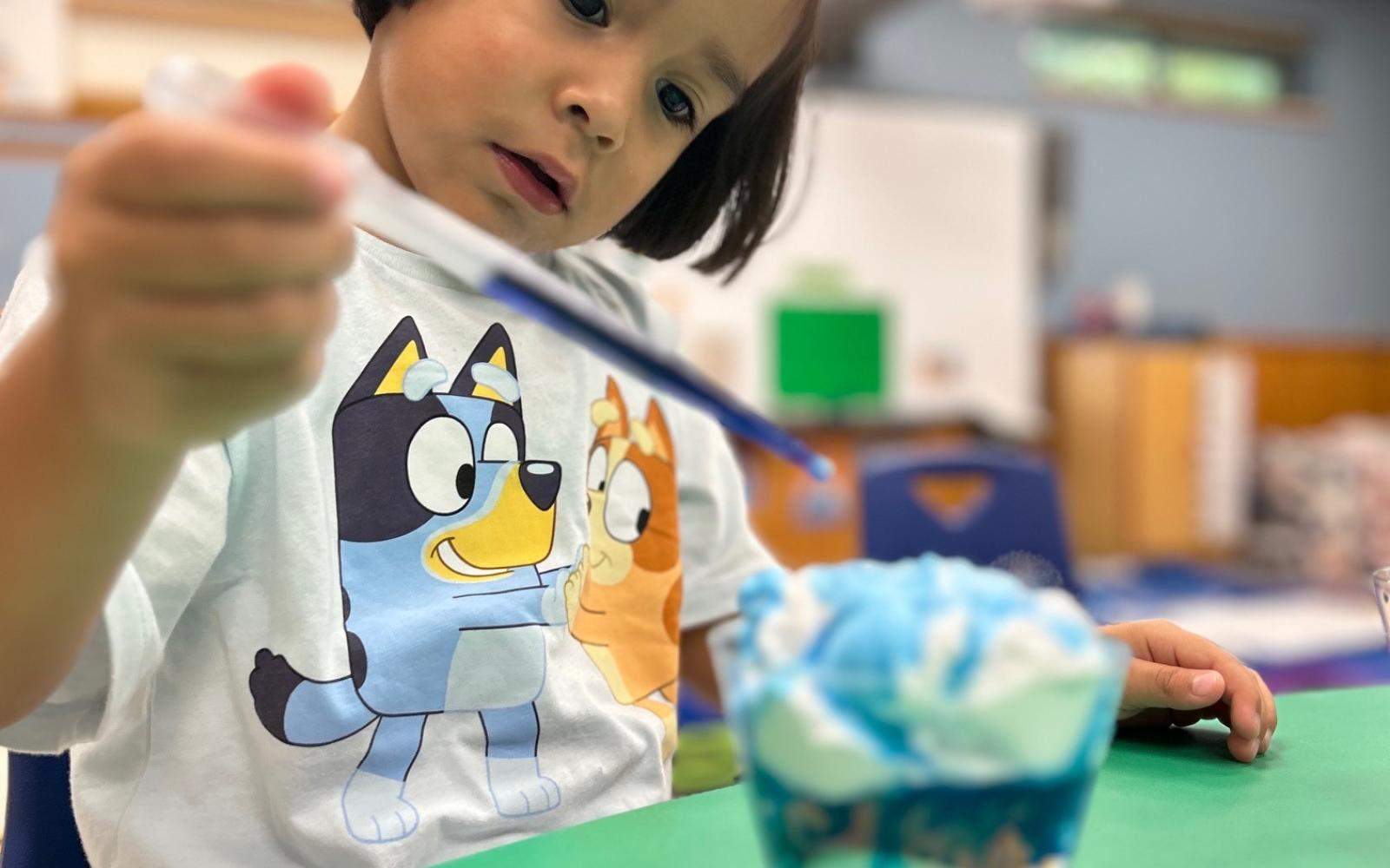 A person doing an experiment in a youth science class