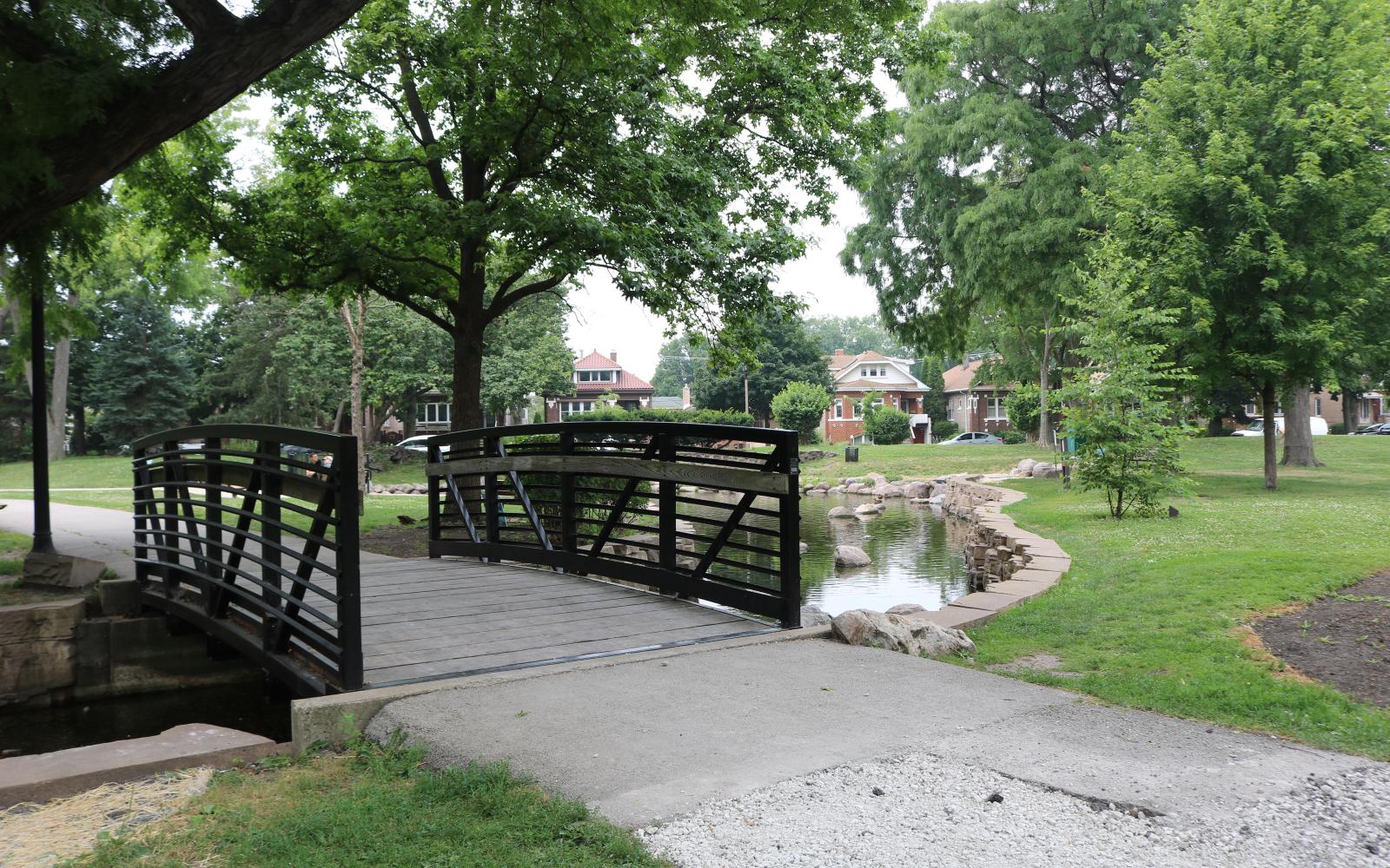 proksa park bridge with walking path and the pond in the background