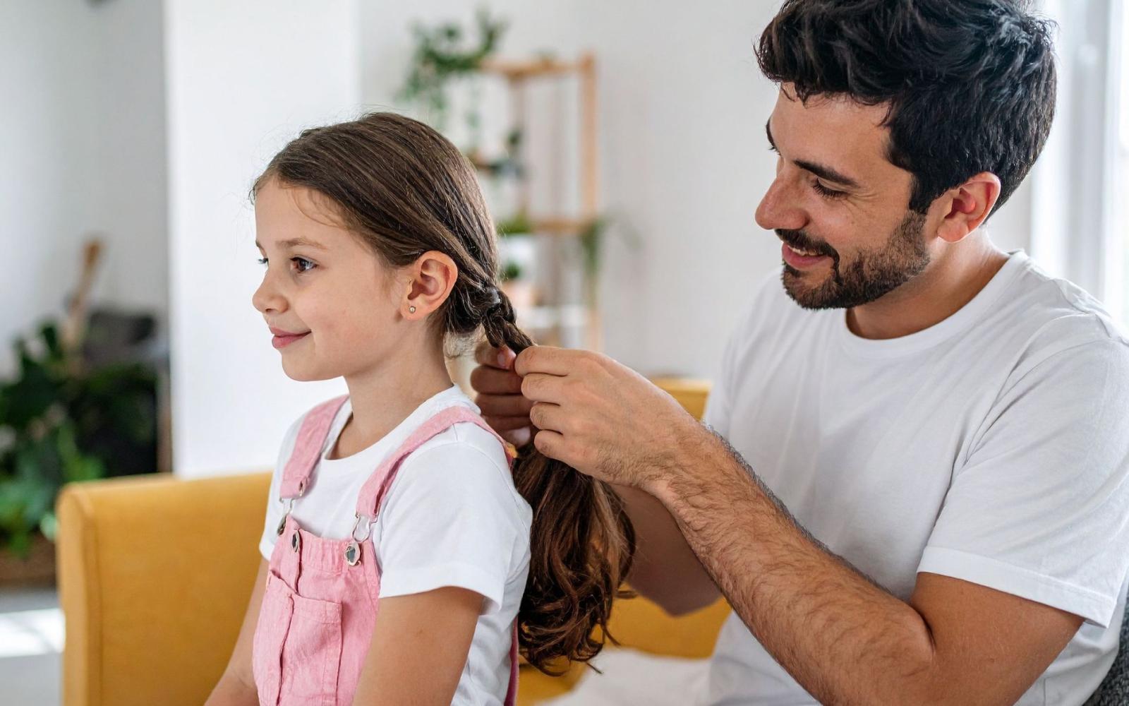 An image of a father doing a daughter's hair
