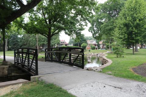 proksa park bridge with walking path and the pond in the background